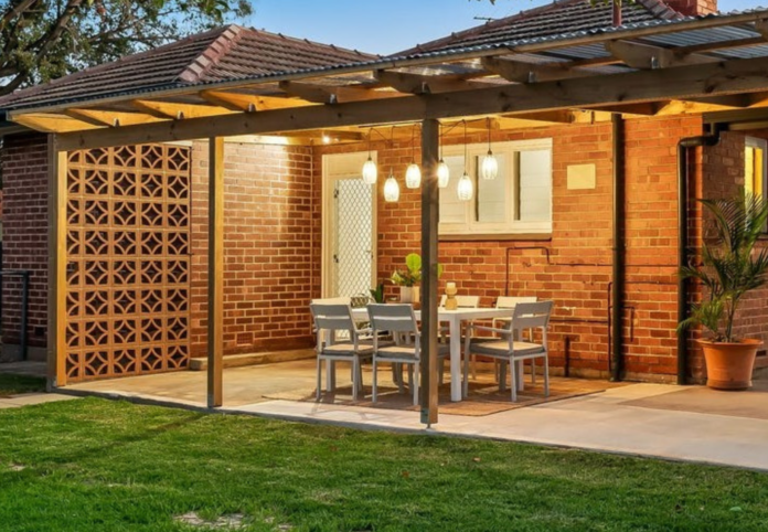 Timber pergola with polycarbonate roofing built over a paved outdoor entertaining area at an Adelaide home